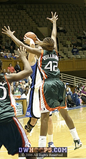 Alison Bales works at the top of the key, defended by Miami's Carla Williams