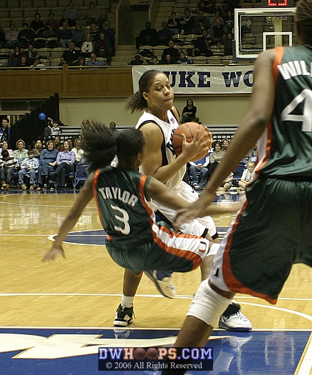 Miami's Renee Taylor takes the charge from Wanisha Smith