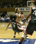 Miami's Renee Taylor takes the charge from Wanisha Smith