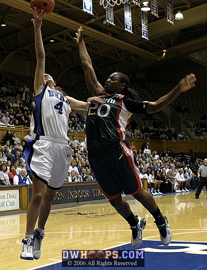 Abby Waner goes up hard on the fast break, fending off the defense effort of Albrey Grimsley