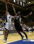 Abby Waner goes up hard on the fast break, fending off the defense effort of Albrey Grimsley