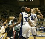 Brittany Mitch and Carrem Gay watch a loose ball fly, as Wanisha Smith starts getting back on defense.