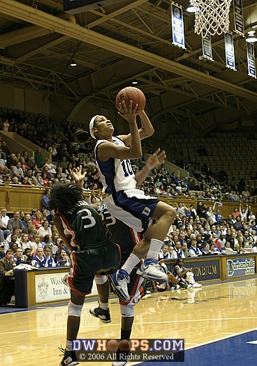 Linsdey Harding elevates for the shot, undercut by Miami's Renee Taylor and Latoya Cunningham