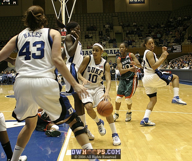 Lindsey Harding threads the needle between screens from Bridgette Mitchell and Wanisha Smith