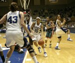 Lindsey Harding threads the needle between screens from Bridgette Mitchell and Wanisha Smith