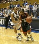 Maurita Reid attempts to drive around Wanisha Smith...