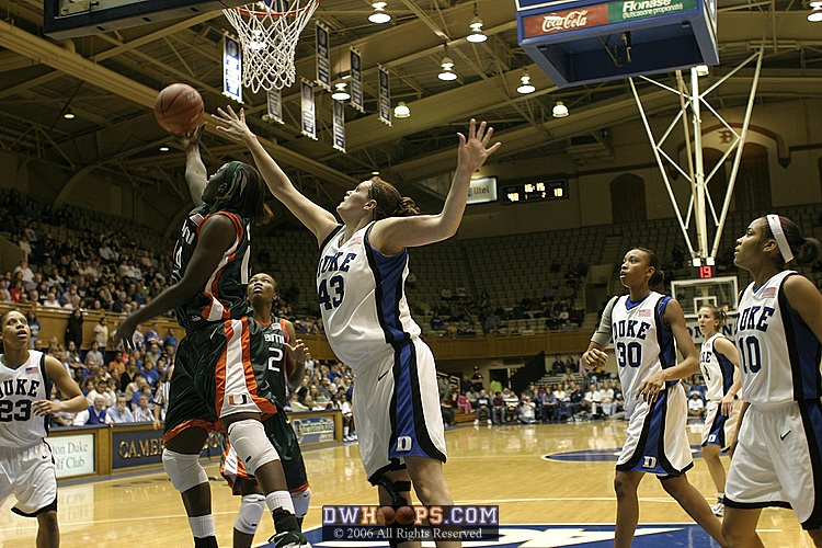 Alison Bales stretches for the ball as Charmaine Clark tips it