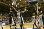 Alison Bales stretches for the ball as Charmaine Clark tips it