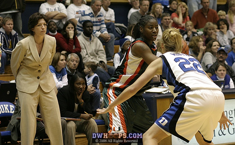 Katie Meier looks on as Brittany Mitch guards Maurita Reid