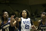 Daphne Mitchell (left), Joy Cheek, and Kentrina Wilson watch a Carrem Gay free throw drop