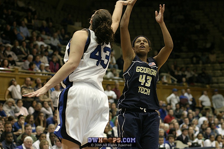 Chioma Nnamaka attempts a 3 pointer over Alison Bales
