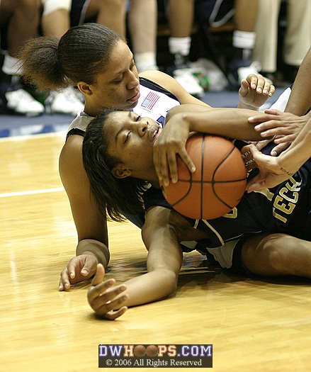 Tech's Jacqua Williams holds onto the ball after falling onto Wanisha Smith