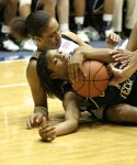 Tech's Jacqua Williams holds onto the ball after falling onto Wanisha Smith