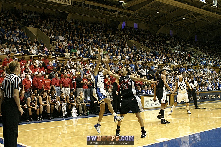 Guarded by Kristi Tolliver, Lindsey Harding attempts a jump shot...