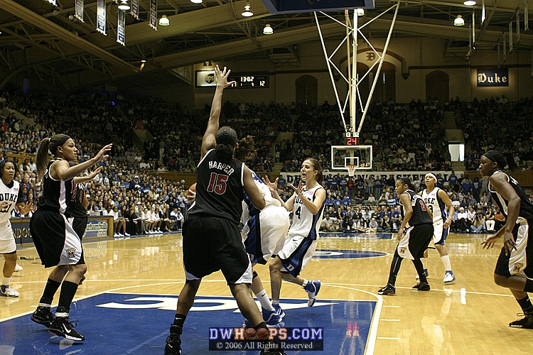 Closely guarded 1-on-1 by Laura Harper, Alison Bales twirls...