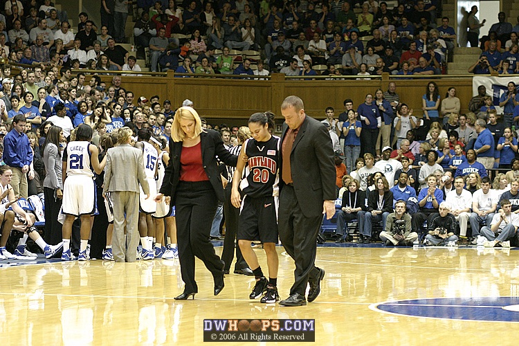 Maryland coaches help Kristi Toliver off the court, after an apparent twisted ankle.  Toliver did not return.