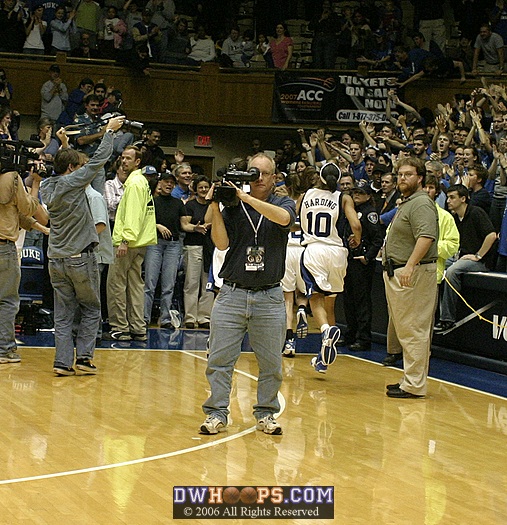 Duke's players make their way through the photographic swarm to the locker room.