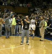 Duke's players make their way through the photographic swarm to the locker room.
