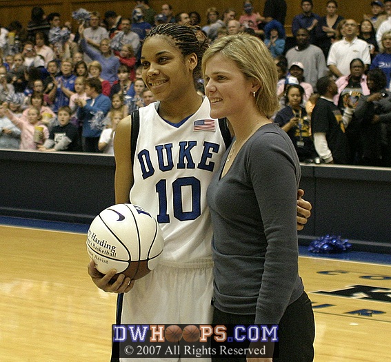 Hilary Howard presents a ball to Duke's new career assist leader, Lindsey Harding