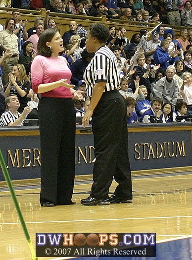 Coach Dunkenburger presumably asks Yvette McKinney why the previous play wasn't a held ball