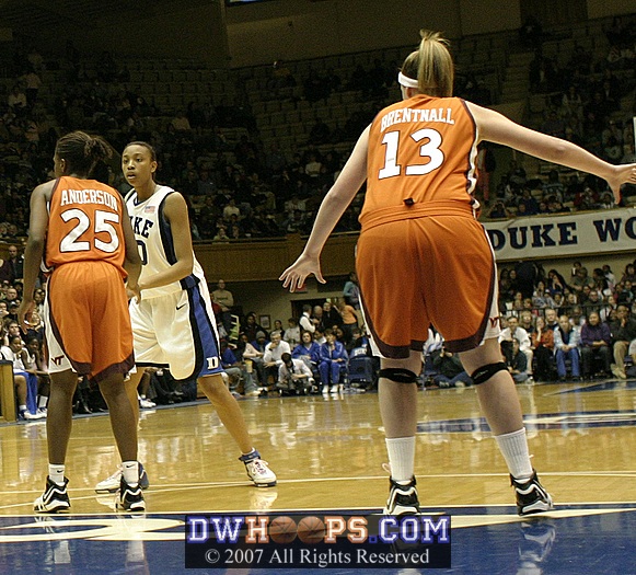 Carrem Gay looks to pass, as the Duke Pep Band exhorts Eleanor Brenthall to "tuck your tag in"