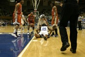 Abby Waner helps up Joy Cheek, who was knocked to the floor by Adrienne Bradshaw.  Band taunts, "Please stop fouling!"