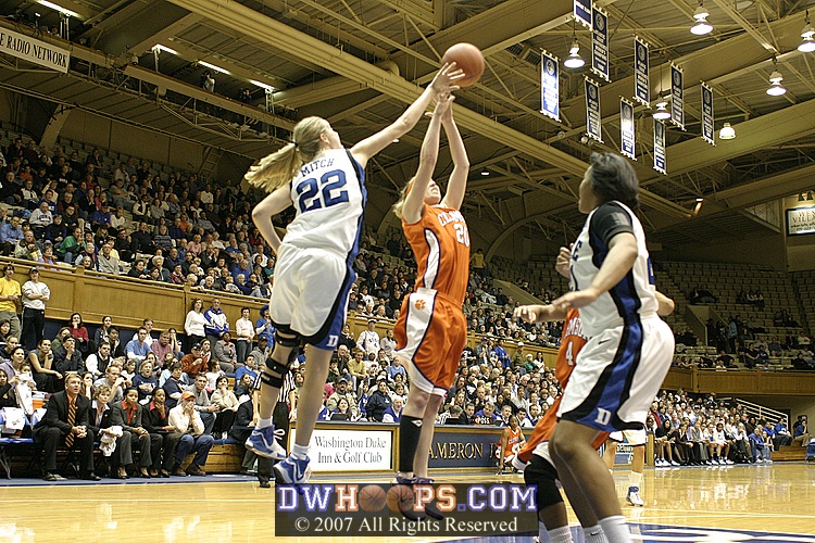 Brittany Mitch goes high to tip a rebound out to Wanisha Smith