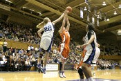 Brittany Mitch goes high to tip a rebound out to Wanisha Smith