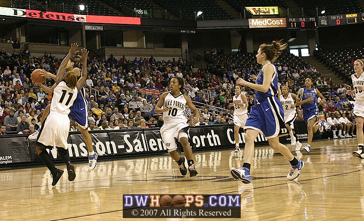 On the break, Lindsey Harding gets Yolanda Lavender off her feet, and the foul call.  After discussion, the referees reversed their original decision and called it "on the floor."