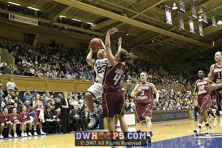 Wanisha Smith drives on Kindyll Dorsey for the hoop...