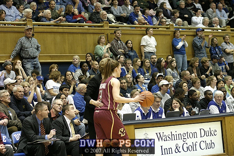 Cathy Inglese councils Sarah Marshall as she brings the ball up the floor.