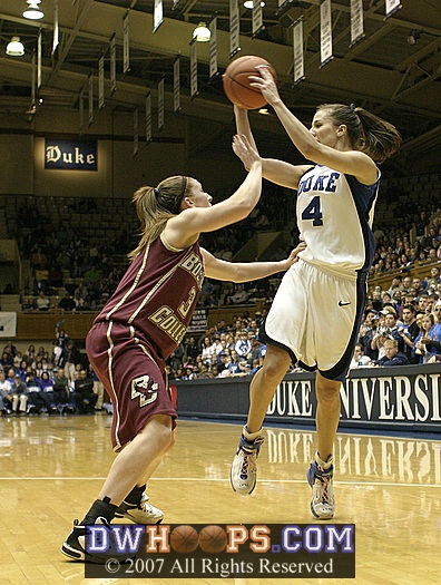 Abby Waner, closely guarded by Sarah Marshall, pulls in a pass