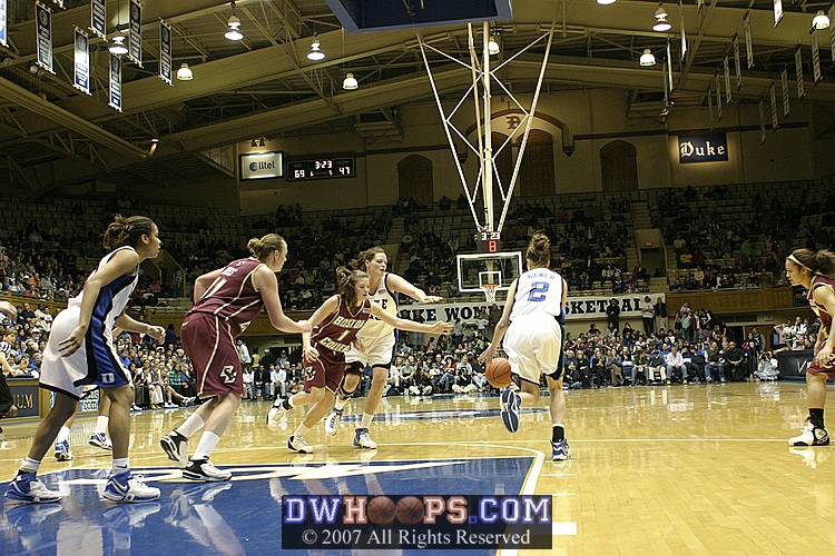 Ayla Brown about to foul Alison Bales after another blocked shot.
