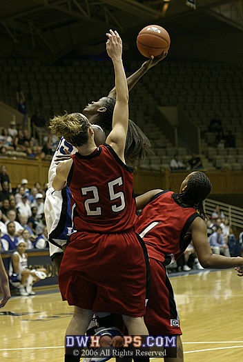 Bridgette Mitchell extends for the rebound, threading the needle between NU's Stefanie Hodell (25) and Shaleyse Smallwood