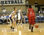 Northeastern's Shaleyse Smallwood brings the ball upcourt as Emily Waner takes a defensive stance...