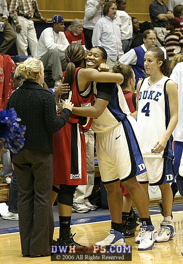 NU's Kim Carr and Joy Cheek embrace in the postgame handshake line