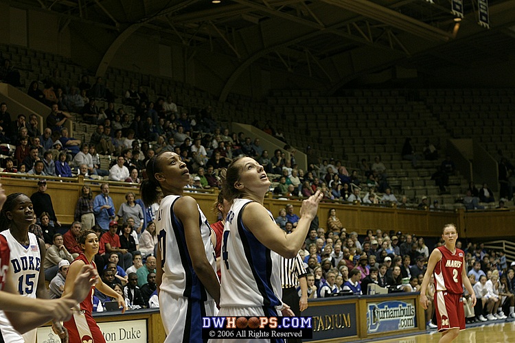 Carrem Gay and Abby Waner watch for the rebound