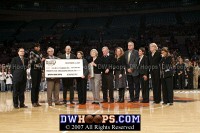  - Presentation of a check to the C.A.R.E. Foundation by the Maggie Dixon Classic.  Center are Maggie's parents, holding a proclamation by the City of New York of "Maggie Dixon Day"