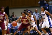 Courtney Ward tries to back up Jasmine Thomas in the paint -  - 