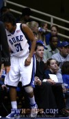 With her knee taped, KJ limps back to the bench before the first half ends -  - 