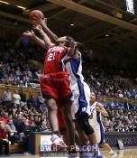 Brittany Strachan and Krystal Thomas stretch for a rebound - 54-41 - 