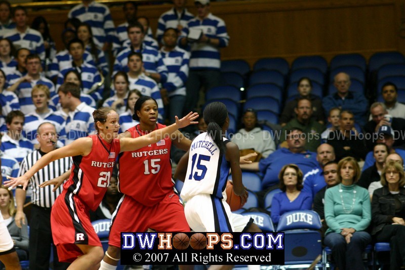 Bridgette Mitchell tries to drive against Heather Zurich (21) and Kia Vaughn (15).  Her layup would miss.