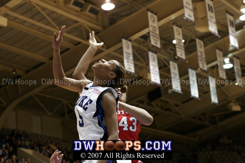 Jasmine Thomas hopes for the rebound, but Rashidat Junaid has put it in