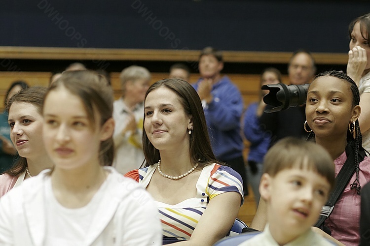 Emily Waner, Abby Waner, and Carrem Gay look on from the second row