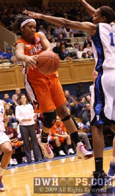 Shanel Harrison pops a pass into the low post under the outstretched arm of Chante Black -  - 
