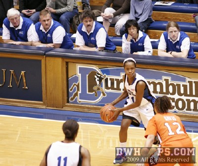 A jury box of sideline officials watches Chelsea Hopkins pass to Black in the high post -  - 