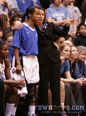 Former college point guard Joanne P. McCallie counsels freshman reserve  Chelsea Hopkins, Duke's point guard of the future before inserting her in the first half -  - HC.D1;