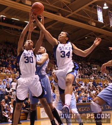 Crystal Thomas soars in for an offensive board and is fouled by Christina DeWitt -  - D30.O15.D34;1,3:56,30-23