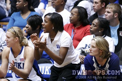 Freshmen Kathleen Scheer and Chelsea Hopkins cheer their teammates on from the bench in the second half