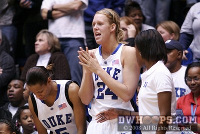 Kathleen Scheer applauds a play from the bench
